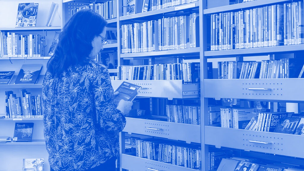 Woman in LIbrary reading books